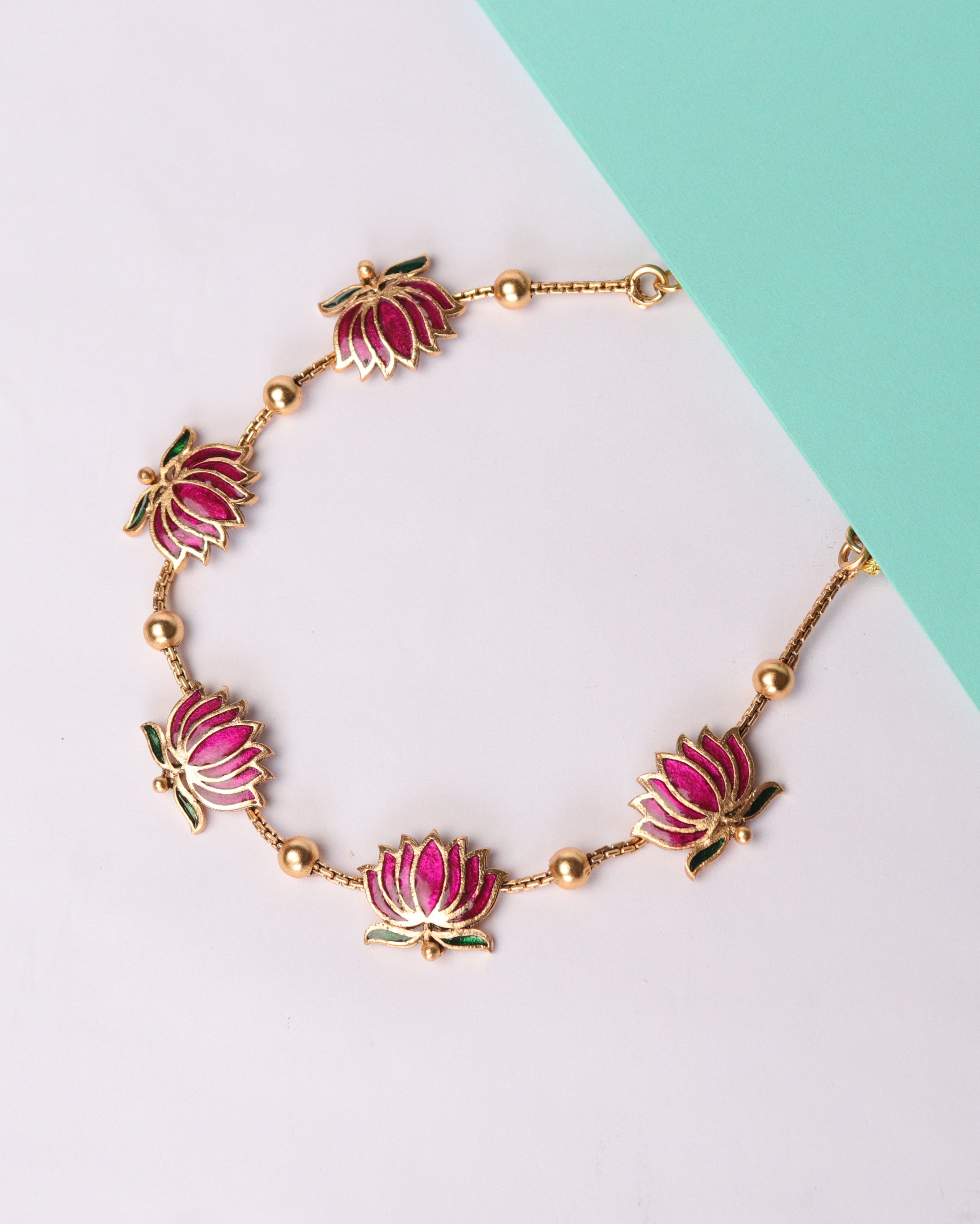 Pink flower-shaped charms on a two-tone background