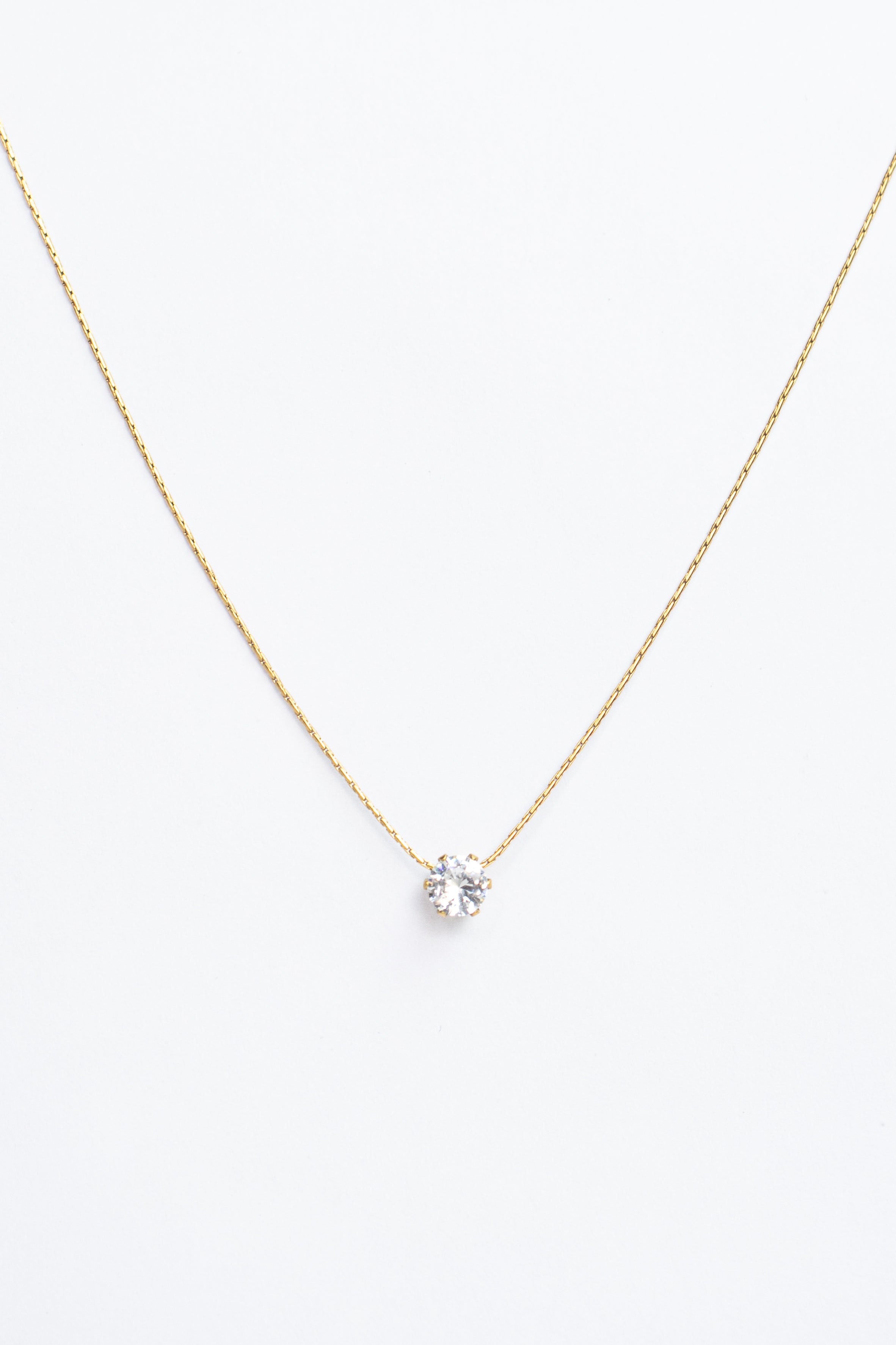 Gold necklace with a small pendant