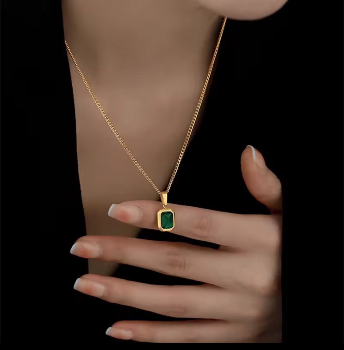 Gold necklace with a green gemstone pendant