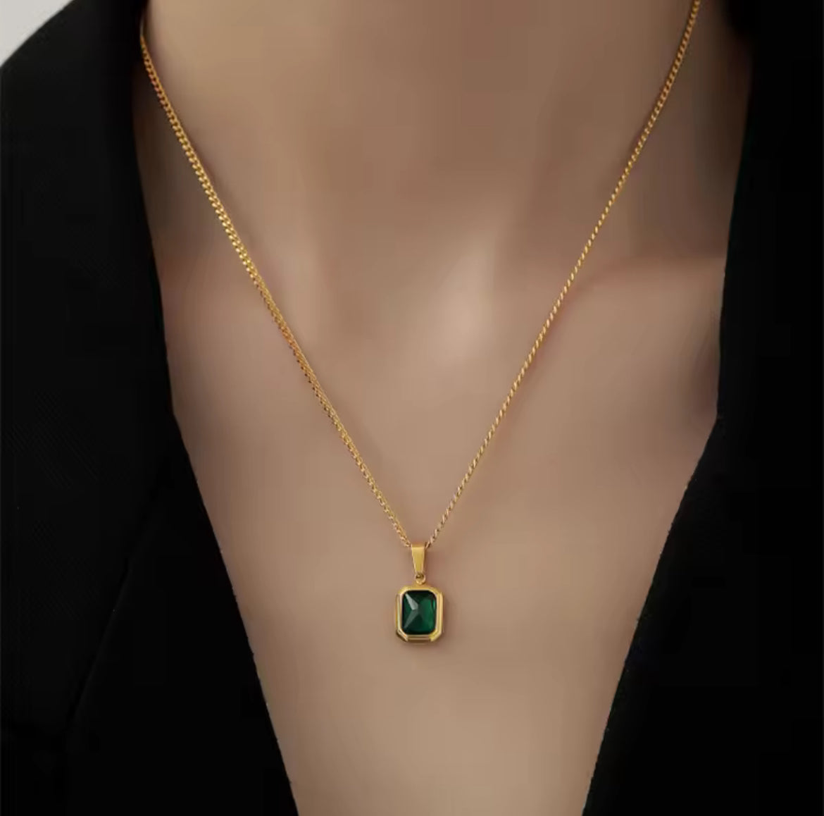 Gold necklace with a green pendant