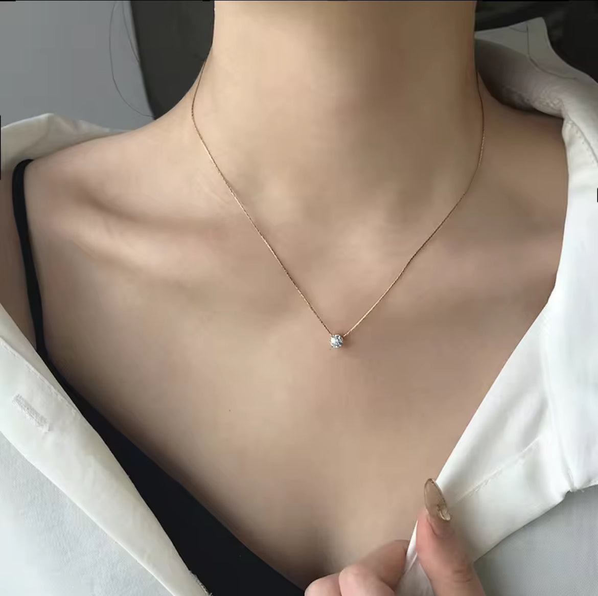 Necklace with a small pendant being worn